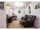 Office space with a desk, chair, and two comfortable leather recliners, creating a versatile area at 1035 Spotted Saddle St, Henderson, NV 89015