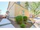 Attractive two-story home featuring manicured landscaping with lush shrubbery, and a serene, park-like atmosphere at 1035 Spotted Saddle St, Henderson, NV 89015