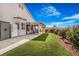 Picturesque backyard featuring well-manicured lawn, patio and vibrant flowers at 1066 Vanlier Ln, Henderson, NV 89015