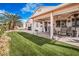 Inviting covered patio with ample seating, fan and lush backyard at 1066 Vanlier Ln, Henderson, NV 89015
