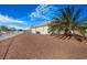 Expansive backyard with gravel, palm tree and a tidy fence line at 1066 Vanlier Ln, Henderson, NV 89015