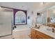 Bright bathroom featuring a shower, soaking tub, window, and a vanity with a sink at 1066 Vanlier Ln, Henderson, NV 89015