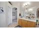 Bright bathroom featuring a large mirror, vanity with a sink, and tiled floors at 1066 Vanlier Ln, Henderson, NV 89015