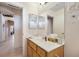 Bathroom featuring a vanity, a large mirror, and access to the hallway at 1066 Vanlier Ln, Henderson, NV 89015