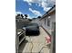 View of the driveway featuring concrete paving, a car cover, and the house's exterior wall at 1066 Vanlier Ln, Henderson, NV 89015