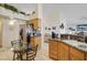 Kitchen with granite counters, stainless refrigerator and a glass table with seating at 1066 Vanlier Ln, Henderson, NV 89015