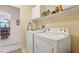 Practical laundry area with white washer, dryer and convenient shelving at 1066 Vanlier Ln, Henderson, NV 89015