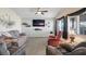 Cozy living room with carpet, ceiling fan, and large windows for ample natural light at 1066 Vanlier Ln, Henderson, NV 89015