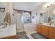 Ensuite bath with dual sinks, walk-in shower, and soaking tub with privacy window at 1066 Vanlier Ln, Henderson, NV 89015