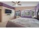 Main bedroom featuring a ceiling fan, bay windows and wall mounted TV at 1066 Vanlier Ln, Henderson, NV 89015