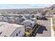This aerial view showcases a residential neighborhood with modern homes and meticulously landscaped yards against a mountain backdrop at 10830 Space Odyssey Ave, Las Vegas, NV 89129
