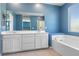 Bright primary bathroom featuring dual sinks, a tub, and a glass shower at 10830 Space Odyssey Ave, Las Vegas, NV 89129