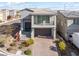 Charming two-story home with a well-manicured front yard and a convenient two-car garage at 10830 Space Odyssey Ave, Las Vegas, NV 89129