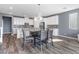 Kitchen and dining area featuring white cabinets, granite counters, and modern pendant lighting at 10830 Space Odyssey Ave, Las Vegas, NV 89129