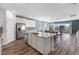 Bright open-concept kitchen with an island, stainless appliances, and access to the balcony at 10830 Space Odyssey Ave, Las Vegas, NV 89129
