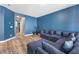 Open-concept living room showcasing wood floors and a comfortable sectional sofa at 10830 Space Odyssey Ave, Las Vegas, NV 89129