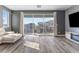 Living area with a balcony overlooking the neighborhood and a comfortable white sofa at 10830 Space Odyssey Ave, Las Vegas, NV 89129