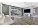 Living room featuring plank floors, a balcony with mountain views, and a modern media center at 10830 Space Odyssey Ave, Las Vegas, NV 89129