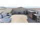 Spacious rooftop deck with comfortable seating and bar area, perfect for entertaining with mountain views at 10830 Space Odyssey Ave, Las Vegas, NV 89129