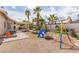 Inviting backyard with a covered patio, picnic table, and play area, ideal for Gathering fun and relaxation at 1133 Mount Olympias Ct, Las Vegas, NV 89110