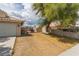 Backyard of property shows desert landscaping and gated access at 1133 Mount Olympias Ct, Las Vegas, NV 89110