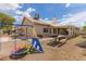 Expansive backyard with play structure, picnic area, covered patio, and lush landscaping, perfect for outdoor living at 1133 Mount Olympias Ct, Las Vegas, NV 89110