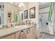 Bathroom featuring a vanity with granite countertop, a large mirror, and tile flooring at 1133 Mount Olympias Ct, Las Vegas, NV 89110