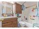Bathroom with a vanity, mirror, tub, and shower combination, offering a functional space at 1133 Mount Olympias Ct, Las Vegas, NV 89110