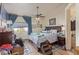Comfortable bedroom with wood floors, ceiling fan, and natural light at 1133 Mount Olympias Ct, Las Vegas, NV 89110