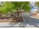 Charming single-story home features a tile roof, desert landscaping, and a two-car garage at 1133 Mount Olympias Ct, Las Vegas, NV 89110