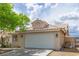 Charming one-story home with a tile roof, two-car garage, and low-maintenance desert landscaping at 1133 Mount Olympias Ct, Las Vegas, NV 89110