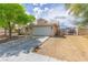 Charming one-story home with a tile roof, two-car garage, and low-maintenance desert landscaping at 1133 Mount Olympias Ct, Las Vegas, NV 89110