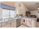 Cozy kitchen with ample countertop space, stainless steel dishwasher, and plenty of natural light at 1133 Mount Olympias Ct, Las Vegas, NV 89110