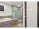 Bathroom with a shower and soaking tub enclosed in glass with tile surround at 1200 I Ave, Boulder City, NV 89005
