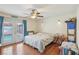 Bedroom featuring hardwood floors, ceiling fan, and French doors leading to an outdoor pool area at 1200 I Ave, Boulder City, NV 89005