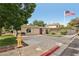 Cozy home with a red door, complemented by a green lawn and mature trees at 1200 I Ave, Boulder City, NV 89005