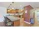 Well-equipped kitchen featuring wooden cabinetry, granite countertops, stainless steel appliances, and a breakfast bar at 1200 I Ave, Boulder City, NV 89005
