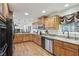 Eat-in kitchen with wooden cabinetry, granite countertops, stainless steel appliances, and hardwood floors at 1200 I Ave, Boulder City, NV 89005