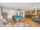 Open-concept kitchen and living room with hardwood floors, ceiling fans, and a billiard table at 1200 I Ave, Boulder City, NV 89005