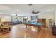 Spacious living room with hardwood floors, ceiling fans, a billiard table and ample natural light at 1200 I Ave, Boulder City, NV 89005