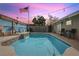 Backyard oasis featuring a sparkling pool, decorative lighting, and a privacy fence with decorative accents at 1200 I Ave, Boulder City, NV 89005