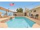 Private in-ground pool with a water feature, surrounded by lush landscaping and seating at 1200 I Ave, Boulder City, NV 89005