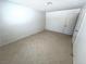 Neutral bedroom with tiled floors and light walls showcases an open doorway and bright natural light at 1208 Winwood St, Las Vegas, NV 89108