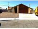 Charming single-story home with a well-maintained front yard and a two-car garage at 1208 Winwood St, Las Vegas, NV 89108