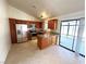 Modern kitchen with stainless steel appliances, an island, and a sliding glass door at 1208 Winwood St, Las Vegas, NV 89108