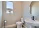 A modern half-bathroom features stylish sink with black faucet and a window providing natural light at 138 Crimson Cactus Ave, Henderson, NV 89011