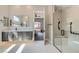 Bright bathroom boasts dual vanities, glass shower and tile floors with easy access to the main bedroom at 138 Crimson Cactus Ave, Henderson, NV 89011