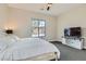 Relaxing bedroom complete with closet, TV and large window, all in a neutral color palette at 138 Crimson Cactus Ave, Henderson, NV 89011