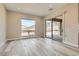 Bonus room featuring wood flooring, a large window with a view, and access to the patio at 138 Crimson Cactus Ave, Henderson, NV 89011