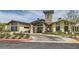 Community clubhouse with lush landscaping and a covered entrance at 138 Crimson Cactus Ave, Henderson, NV 89011